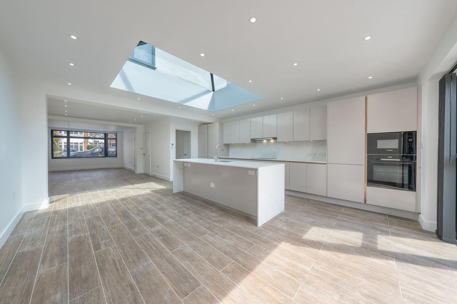 Open-plan living and kitchen space in a completed Malux project